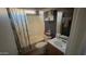 A full bathroom has a shower and tub combination with decorative shower curtain at 15729 W Lundberg St, Surprise, AZ 85374