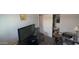This bedroom features neutral paint, television, and closet space for storage at 15729 W Lundberg St, Surprise, AZ 85374