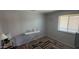 This bedroom is a blank slate with neutral colors, large window, and space for storage at 15729 W Lundberg St, Surprise, AZ 85374