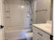 White bathroom features a shower-tub combo with tile surround and modern vanity at 2155 W Farmdale Ave # 8, Mesa, AZ 85202