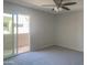 Bedroom with a ceiling fan and a sliding glass door to the balcony at 2155 W Farmdale Ave # 8, Mesa, AZ 85202