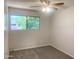 Bedroom featuring a ceiling fan, neutral walls, and a large window with bright natural light at 2155 W Farmdale Ave # 8, Mesa, AZ 85202
