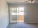 Bedroom with neutral gray paint, a ceiling fan, and a sliding door to the balcony at 2155 W Farmdale Ave # 8, Mesa, AZ 85202