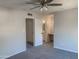 Carpeted bedroom with a ceiling fan and view into an ensuite bathroom at 2155 W Farmdale Ave # 8, Mesa, AZ 85202