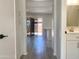 Hallway with gray floors, a partial view of a sink and sliding glass door to a patio at 2155 W Farmdale Ave # 8, Mesa, AZ 85202