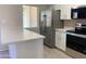 Quartz countertop, stainless appliances, updated kitchen with breakfast bar and eat-in area at 2155 W Farmdale Ave # 8, Mesa, AZ 85202
