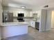 Stylish renovated kitchen featuring new stainless steel appliances, white cabinets, and breakfast bar at 2155 W Farmdale Ave # 8, Mesa, AZ 85202