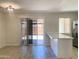Bright open-concept kitchen/dining area with modern light fixture, breakfast bar and sliding glass doors to backyard at 2155 W Farmdale Ave # 8, Mesa, AZ 85202