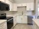Renovated kitchen with quartz counters, stainless appliances, and white cabinets at 2155 W Farmdale Ave # 8, Mesa, AZ 85202