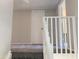 Carpeted landing with white railing and a closed door at 2155 W Farmdale Ave # 8, Mesa, AZ 85202