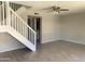Bright living room with staircase, light-colored tile floors, and a ceiling fan at 2155 W Farmdale Ave # 8, Mesa, AZ 85202