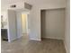 Neutral-toned living room features wood-look flooring and closet or storage area at 2155 W Farmdale Ave # 8, Mesa, AZ 85202