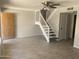 Inviting living room featuring a staircase, tile flooring, ceiling fan and front door at 2155 W Farmdale Ave # 8, Mesa, AZ 85202