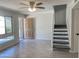 Open living room with wood-look tile flooring, staircase, and a front door view at 2155 W Farmdale Ave # 8, Mesa, AZ 85202