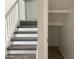 Carpeted staircase with white railing leading to the next level at 2155 W Farmdale Ave # 8, Mesa, AZ 85202