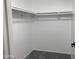 Spacious walk-in closet with ample hanging space on multiple rods and neutral carpet at 2155 W Farmdale Ave # 8, Mesa, AZ 85202