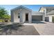 Charming single-story home featuring a gray exterior, covered porch, and brick driveway at 2324 E Marguerite Ave, Phoenix, AZ 85040