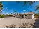 Spacious backyard with rock landscaping, palm trees, and blue skies at 2348 E Diamond Ave, Mesa, AZ 85204
