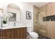Charming bathroom features a decorative mirror, sleek vanity, and tiled shower with niche at 2348 E Diamond Ave, Mesa, AZ 85204