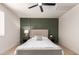 Comfortable bedroom offers a green feature wall, queen bed, and soft natural light at 2348 E Diamond Ave, Mesa, AZ 85204