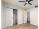 Bright bedroom features wood floors, closet with white doors and ceiling fan at 2348 E Diamond Ave, Mesa, AZ 85204