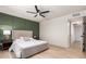 Relaxing bedroom boasts a queen bed, statement wall, and a ceiling fan at 2348 E Diamond Ave, Mesa, AZ 85204