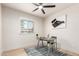 Well-lit bedroom with fan, window, desk, chair, and an abstract painting at 2348 E Diamond Ave, Mesa, AZ 85204