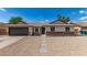 Charming single-story home with desert landscaping, complemented by a two car garage and palm trees at 2348 E Diamond Ave, Mesa, AZ 85204