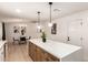 Modern kitchen featuring white cabinets, stainless appliances, and a quartz countertop island with seating at 2348 E Diamond Ave, Mesa, AZ 85204