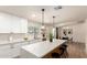 Modern kitchen featuring white cabinets, stainless appliances, and a quartz countertop island with seating at 2348 E Diamond Ave, Mesa, AZ 85204