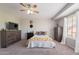Bedroom with ceiling fan, closet space, and a cozy atmosphere at 2455 E Broadway Rd # 115, Mesa, AZ 85204