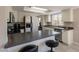 Bright kitchen features modern appliances, breakfast bar, and ample cabinet space at 2455 E Broadway Rd # 115, Mesa, AZ 85204