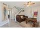 Inviting living room with tile floors, staircase, and leather sofa, under a ceiling fan at 2455 E Broadway Rd # 115, Mesa, AZ 85204