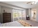 Bright main bedroom featuring large windows, neutral walls and carpeted flooring at 2455 E Broadway Rd # 115, Mesa, AZ 85204