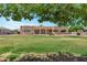 Expansive backyard showcasing the home's architecture and lush green lawn at 24615 S 182Nd Pl, Gilbert, AZ 85298