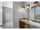 Bathroom boasting a double sink vanity with decorative lighting, a view into the bedroom and neutral colored walls at 24615 S 182Nd Pl, Gilbert, AZ 85298