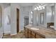 Bathroom featuring a double sink vanity, mirrors, and stone countertops at 24615 S 182Nd Pl, Gilbert, AZ 85298
