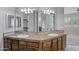 Bathroom showcasing double sinks, mirrors, cabinets, and countertops at 24615 S 182Nd Pl, Gilbert, AZ 85298