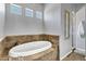 Modern bathroom featuring a large tub with beige tile at 24615 S 182Nd Pl, Gilbert, AZ 85298