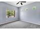 A modern bedroom with multiple windows and a ceiling fan, offering ample natural light at 24615 S 182Nd Pl, Gilbert, AZ 85298