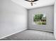 A bright bedroom with a ceiling fan and a window offering views of the outdoors at 24615 S 182Nd Pl, Gilbert, AZ 85298