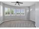 Bright bedroom boasts a ceiling fan and big windows with views of the outdoors at 24615 S 182Nd Pl, Gilbert, AZ 85298