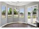 Cozy breakfast nook boasts wood floors, modern lighting, large windows, and a door to the backyard at 24615 S 182Nd Pl, Gilbert, AZ 85298
