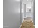 Hallway with tile floors, neutral walls, and white trim leads to other rooms in this well-maintained home at 24615 S 182Nd Pl, Gilbert, AZ 85298