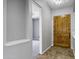 Hallway with travertine floors leading to a bedroom with a rustic wooden door at 24615 S 182Nd Pl, Gilbert, AZ 85298