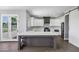 Spacious kitchen featuring white cabinets, stainless steel appliances, and a gray kitchen island at 24615 S 182Nd Pl, Gilbert, AZ 85298