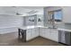 Open concept kitchen featuring white cabinets, gray island, and stainless steel appliances overlooking the Gathering room at 24615 S 182Nd Pl, Gilbert, AZ 85298