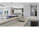 Gourmet kitchen features white cabinets, gray island, stainless appliances, and tile backsplash at 24615 S 182Nd Pl, Gilbert, AZ 85298