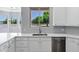 Kitchen detail showcasing white cabinets, quartz countertops, and a stainless steel faucet at 24615 S 182Nd Pl, Gilbert, AZ 85298