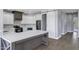This gorgeous kitchen features white cabinetry, stainless steel appliances, and an island with bar seating at 24615 S 182Nd Pl, Gilbert, AZ 85298